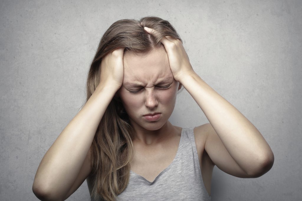 Woman with hands on head wanting to manage anxiety