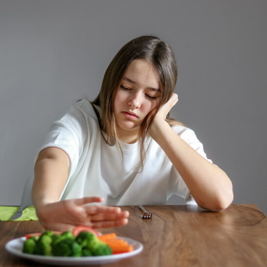 Girl picking at food and needing ARFID Therapy